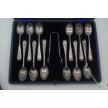 A set of twelve Edwardian silver teaspoons, having bright cut floral engraved decoration, with