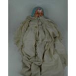 An Edwardian metal painted headed doll, h.45cm, marked PR1/50R to the back of the head