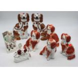 A pair of Staffordshire models of spaniels, decorated in copper lustre, height 22cm, together with