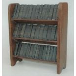 An early 20th century three-tier miniature booktrough, containing 40 miniature works of Shakespeare