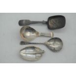 An early 19th century silver tea caddy spoon, of plain undecorated form; together with three 19th