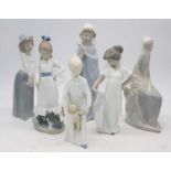 A collection of six Nao porcelain figures of girls, the largest height 27cm