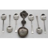 A Chinese white metal spoon, having engraved bowl, flower head stem, and pressed terminal in the