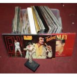 A box of vintage records and collectables relating to Elvis Presleyextra images