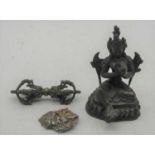 A bronze alloy model of a Tibetan deity, in typical seated lotus pose, h.12cm; together with a