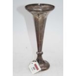 A George V silver spill vase, of fluted trumpet shape, on loaded base, h.20cm