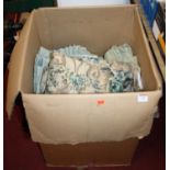 A box of assorted curtains, being floral and other examples