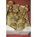 A collection of 19th century and later brass candlesticks