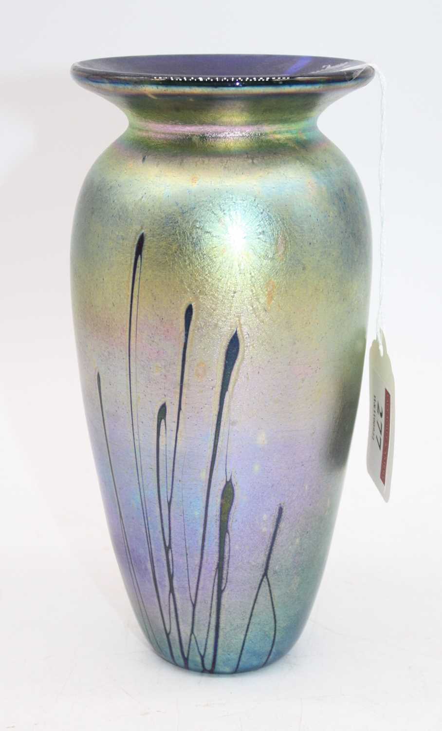 A late 20th century iridescent glass vase, having a flared rim to a tapering body, with indistinct