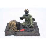 An Austrian style bronzed metal figure of a seated snake charmer, height 8cm