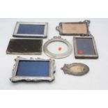 A collection of assorted silver clad easel photograph frames, to include circular example surmounted