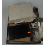 A box of mid-20th century ephemera, to include postcards, stamps, and letters
