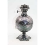 A late Victorian silver oil lamp, having unmarked burner over a spherical spot hammered body, on