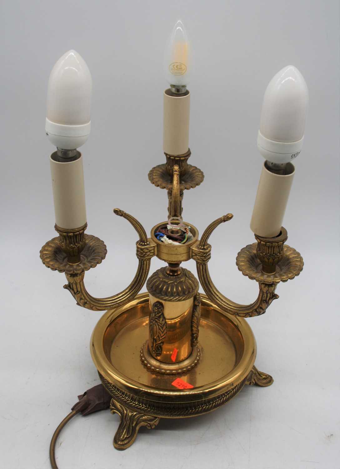 A 20th century brass three-branch table lamp, having toleware type shade, h.40cm (including