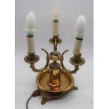 A 20th century brass three-branch table lamp, having toleware type shade, h.40cm (including