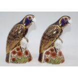 A pair of Royal Crown Derby desk ornaments, each in the form of a bronze winged parrot, and having a