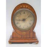 A 20th century mahogany cased mantel clock, the dial showing Roman numerals, standing upon four