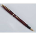 A Conway Stewart 85L fountain pen, in red herringbone with gold trim, the barrel engraved Conway