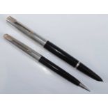 A cased Parker 51 fountain pen and pencil set, in black with silver caps, the pen barrel faintly