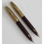 Two Sheaffer PFM V fountain pens, made in Australia, in burgundy with gold trim, rolled gold caps