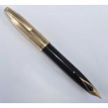 A Sheaffer PFM fountain pen, in black with gold trim, the cap engraved SHEAFFER'S MADE IN U.S.A.