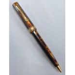 An Omas faceted ballpoint pen from the Arte Italiana Collection, in Arco Brown with gold plated
