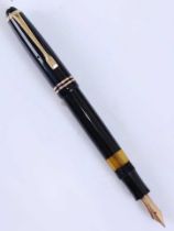 A Montblanc 244 fountain pen, black with gold plated fittings, the blind cap base inscribed 244, the