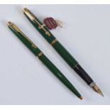 A Parker 75 fountain pen and ballpoint pen set, in malachite green with gold plated fittings, the