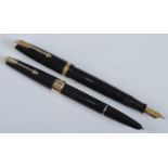 Two Parker fountain pens, in black with gold trim, one being a Duofold, the barrel engraved PARKER