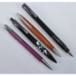 Four Lamy pens, being one fountain and three ballpoints, ballpoints including a 2000 Taxus in dark