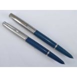 Two Parker 51 fountain pens, in teal with silver trim, each faintly engraved to the barrels; one