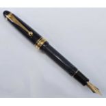 A Pilot Custom 823 fountain pen, in black with gold trim, having semi-translucent barrel, the nib