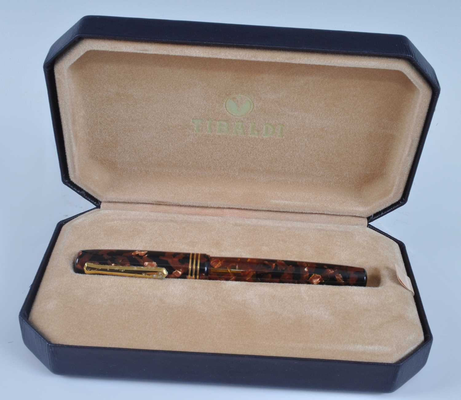 A cased Tibaldi Iride fountain pen, in transparent red celluloid with gold trim, the branded nib - Image 6 of 6