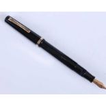 An Omas Extra fountain pen, of black faceted form with gold plated trim, the barrel inscribed OMAS