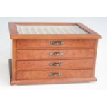 A rosewood effect four-drawer fountain pen collectors chest, having glazed inset lid and lined