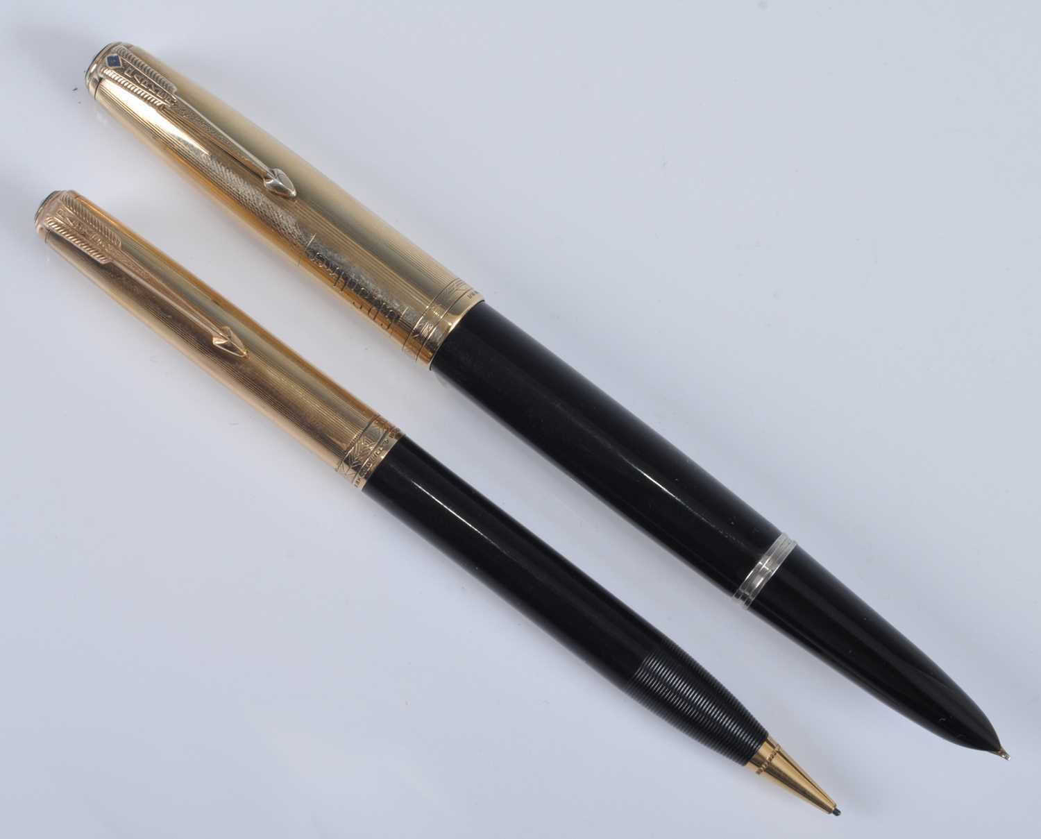 A Parker 51 fountain pen and pencil set, in black with gold trim, the pen barrel engraved PARKER "