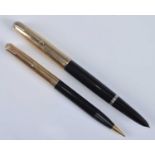 A Parker 51 fountain pen and pencil set, in black with gold trim, the pen barrel engraved PARKER "