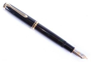 A Pelikan Souverän M1000 fountain pen in black. having gold plated fittings including beak shaped