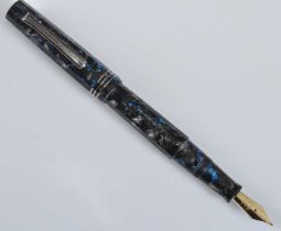 A cased Tibaldi Impero fountain pen, in silver-grey flake faceted celluloid with electric blue