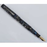 A cased Tibaldi Impero fountain pen, in silver-grey flake faceted celluloid with electric blue