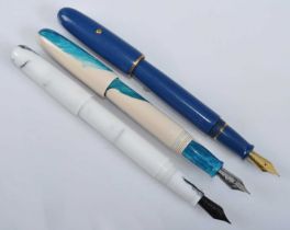 Three Clyde Pen Company fountain pens, being a Blue Torpedo with gold filled trim, Life's a Beach