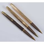Three Parker 50 Falcon fountain pens, in Gold, Gold Signet, and Brown, the two gold examples