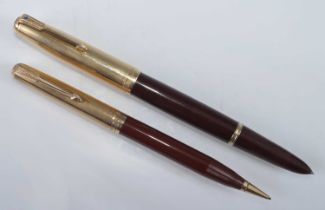 A Parker 51 double-jewelled fountain pen and pencil, in Cordovan brown with filled gold caps, the