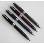 Four Sheaffer Compact fountain pens, circa 1960s, being black, navy blue, burgundy and grey, all