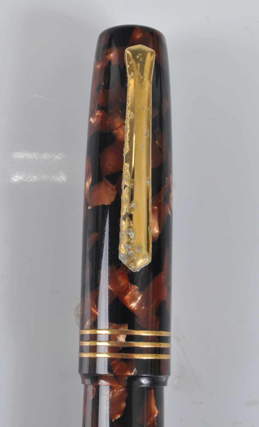 A cased Tibaldi Iride fountain pen, in transparent red celluloid with gold trim, the branded nib - Image 3 of 6