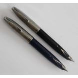 Two Sheaffer PFM fountain pens, in dark blue and black, both with silver fittings and palladium