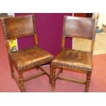 A set of four Cromwellian style joined oak leather pad back and seat and further brass studded