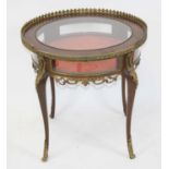A late 19th century French walnut bijouterie table, the circular tilt-top with central glazed