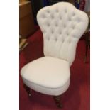 A Victorian figured walnut framed and buttoned fabric upholstered nursing chair