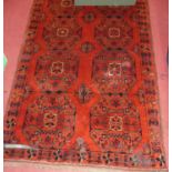 A Persian woollen red ground bokhara rug, 190 x 116cm